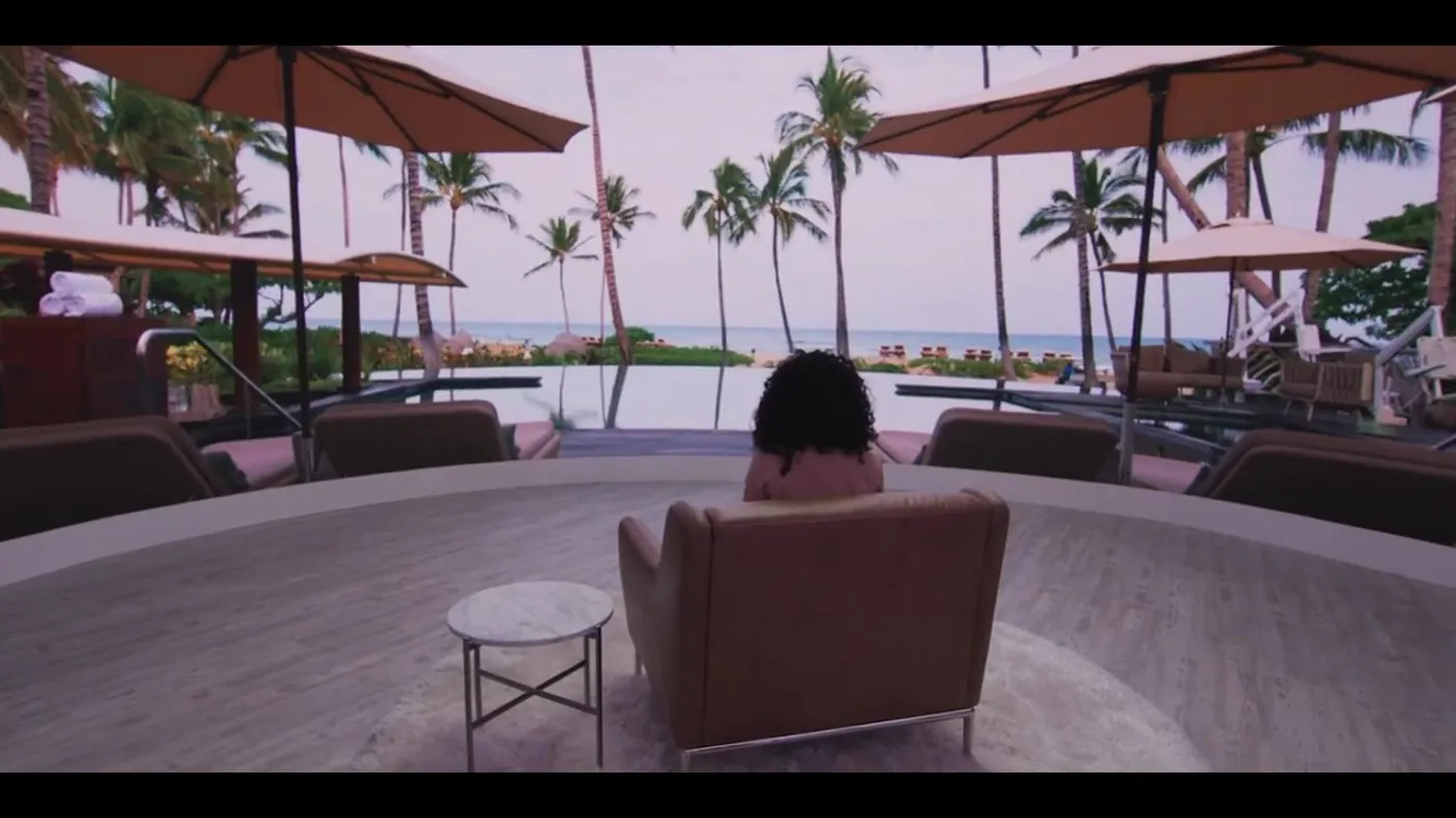 A chair on a soundstage as the wall opens onto a Four Seasons resort